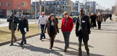 Convention participants with name badges walking along a street in Freiburg