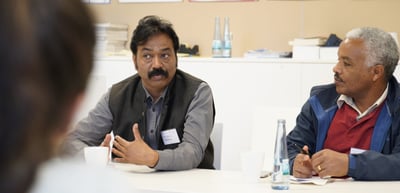 Two laureates talking at a round table
