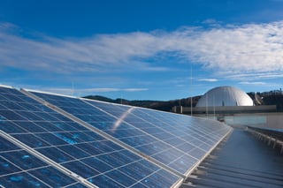 Solar panels on the roof of the Richard-Fehrenbach-Schule in Freiburg, a domed building in the background