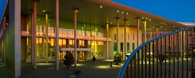 Konzerthaus Freiburg at dusk with its glass facade lit from inside