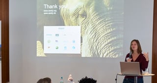 A laureate presenting next to a projected slide with an elephant and the text: Thank you! www.awely.org www.awely.de