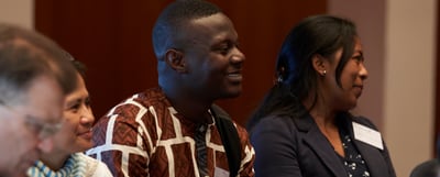 Participants listening and smiling during a session