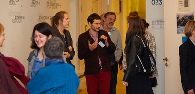 Participants talking in a school corridor