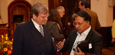 Two men in conversation at the reception in a historic room