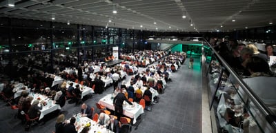 Guests at long dinner tables at the Green Dinner, seen from above