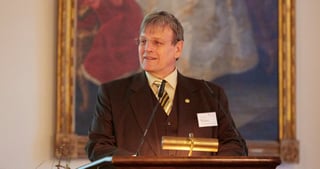 Eicke R. Weber speaking at a lectern