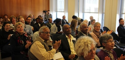 Audience applauding in a seminar room