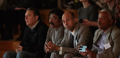 Laureates seated in the audience, listening