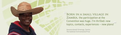 Hammerskjoeld Simwinga in a straw hat with his quote: "Born in a small village in Zambia, the participation at the Convention was huge. I'm thrilled: new topics, contacts, experiences – new plans!" Hammerskjoeld Simwinga, Zambia, The Goldman Environmental Prize