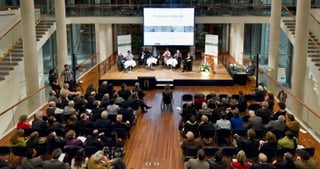 Panel discussion on the stage of a hall in front of a large audience, the screen reads "On the way to Rio+20"
