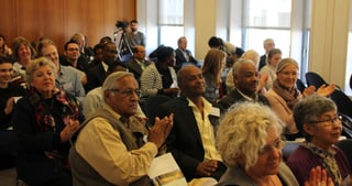 Audience applauding in a seminar room