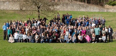 Group photo of the laureates and young talents on a meadow