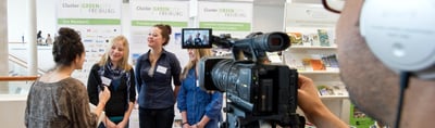 Students giving a filmed interview at an exhibition stand of Green City Freiburg