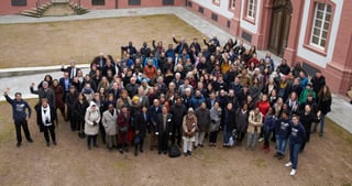 Group photo of the participants in the courtyard of the UWC Robert Bosch College, seen from above