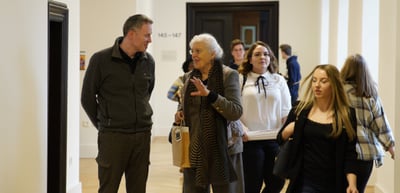 Participants walking through a corridor of the college