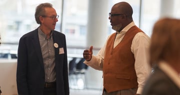 Two laureates talking to each other in a foyer