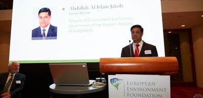 Man at a lectern of the European Environment Foundation next to a slide introducing "Abdullah Al Islam Jakob, Deputy Minister, Ministry of Environment and Forests, Government of the People's Republic of Bangladesh"
