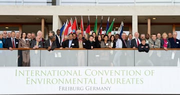 Participants of the 2nd ICEL on a balcony above a banner reading International Convention of Environmental Laureates, Freiburg Germany