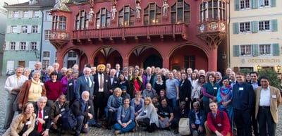 Group photo of the participants of the 3rd convention on a square in front of the red Historisches Kaufhaus in Freiburg