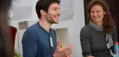 Smiling young man and young woman in conversation